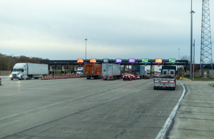 Newark, New Jersey, USA- 01.19.2023: E-Zpass toll plaza. Wide view of a highway toll station with multiple trucks and vehicles, highlighting efficient road management