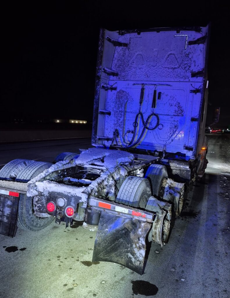 A bobtail truck with two tires missing