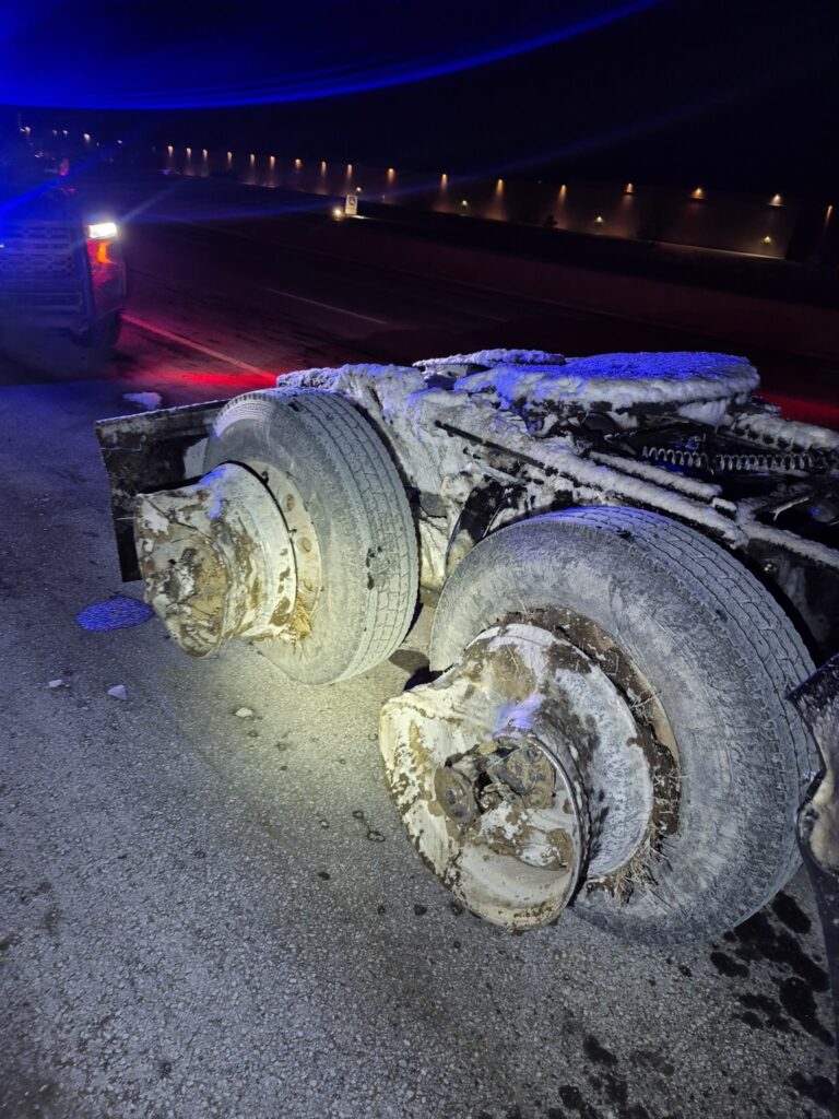 Truck with missing tires and damaged wheel