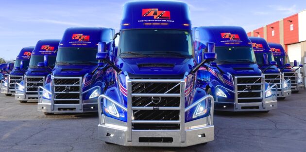 A row of blue semi trucks