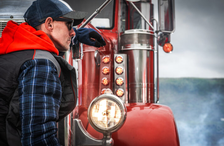 A truck driver walks to his truck.