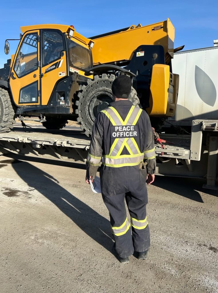 An enforcement officer inspecting a truck