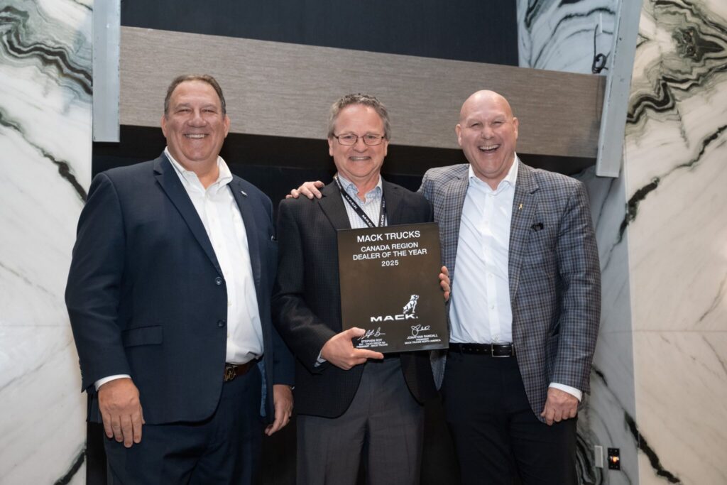 Picture of three men with a trophy