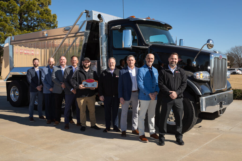 Men standing in front of a truck