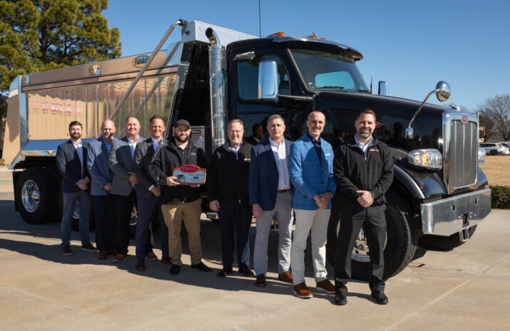 Men standing in front of a truck