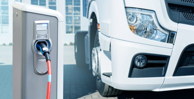 Electric vehicles charging station on a background of a truck alternate text for this image