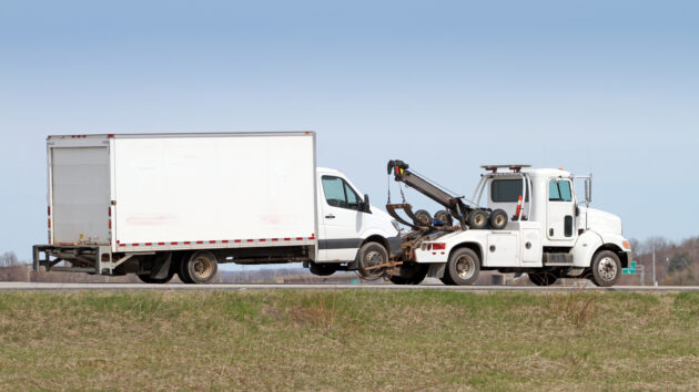 Tow Truck Towing A Truck On Highway in Canada