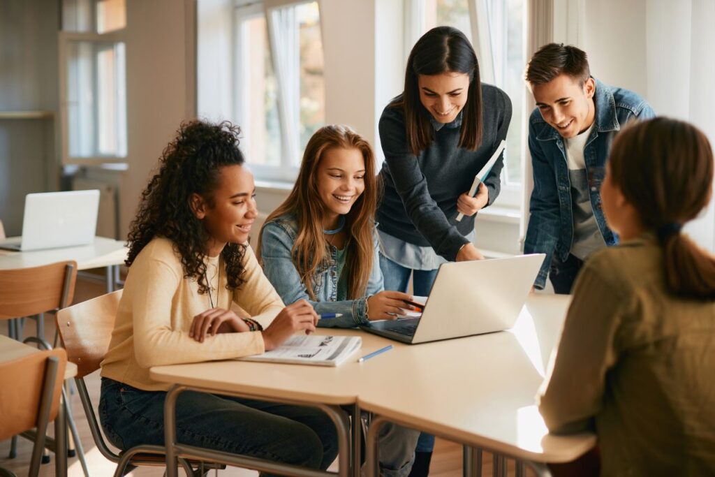 students collaborating around a computer