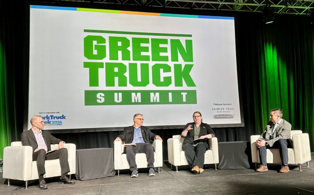 Four people seated on a stage