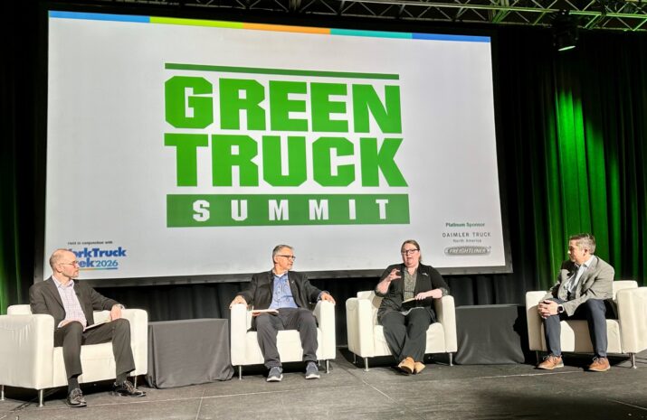 Four people seated on a stage