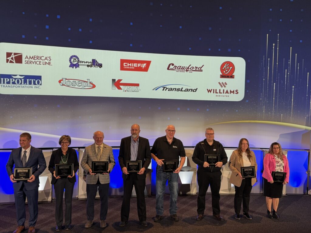 fleet representatives on stage, holding awards, group photo