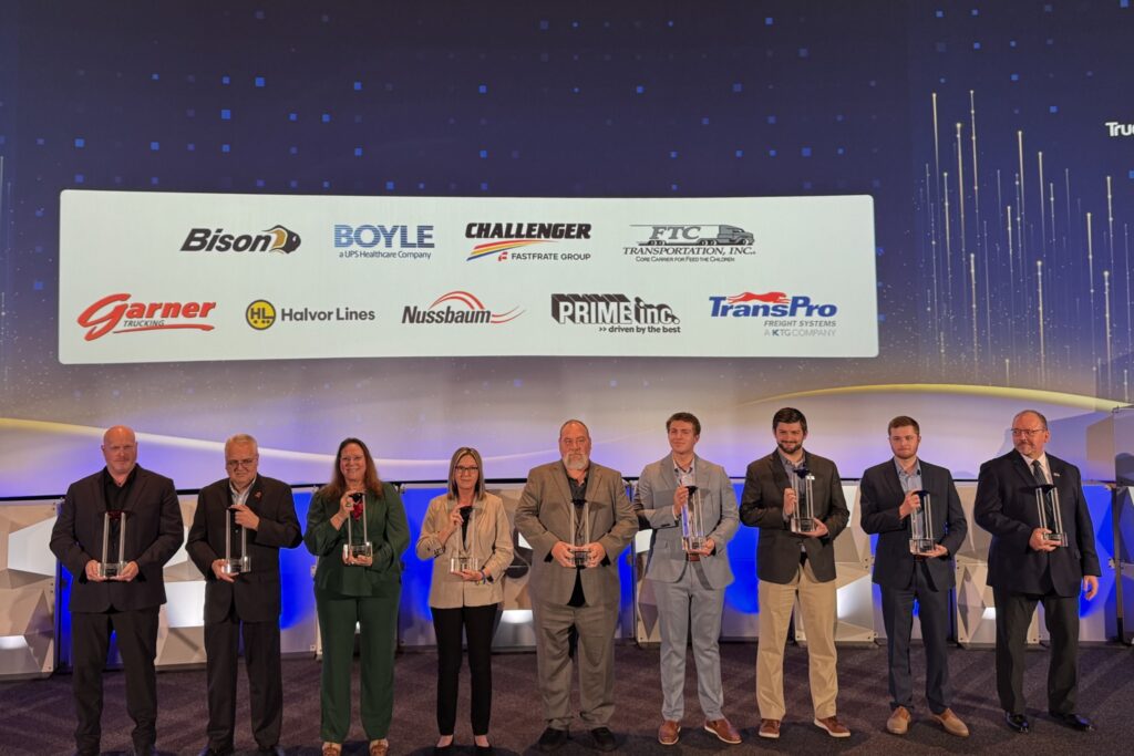 fleet representatives on stage, holding awards, group photo