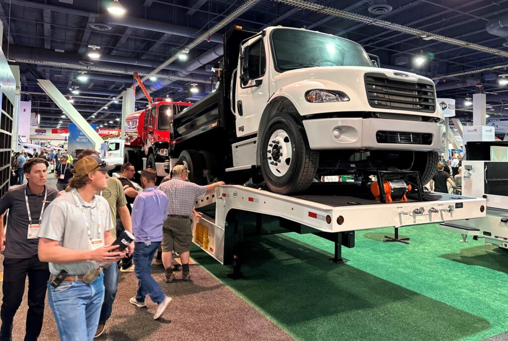 Work trucks on a step deck trailer