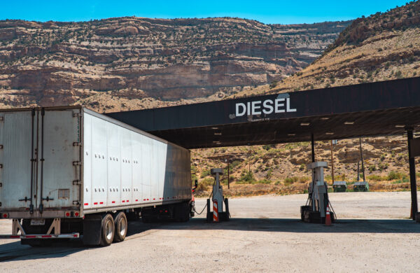 A truck pulls into a fueling station.