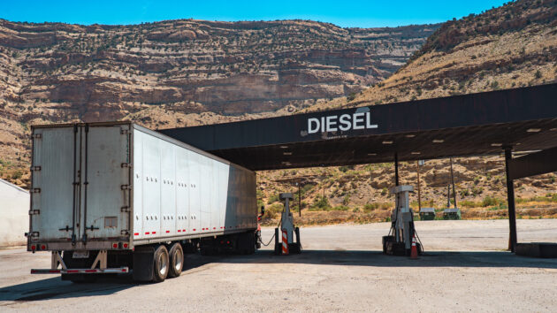A truck pulls into a fueling station.