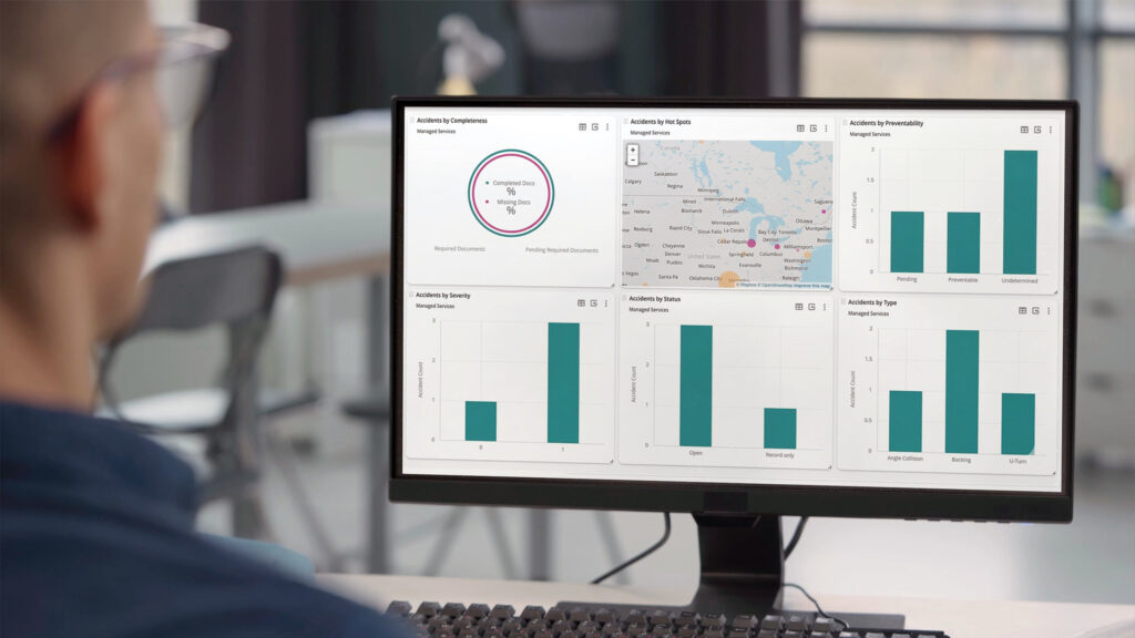 man at desk looking at computer screen