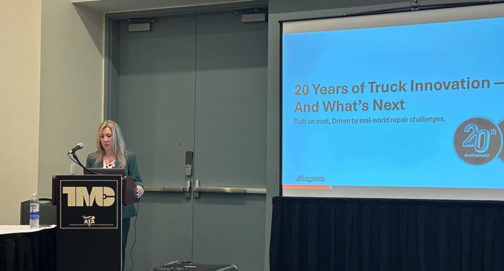 Kristy Coffman, director of Mitchell 1’s Commercial Vehicle Group at podium