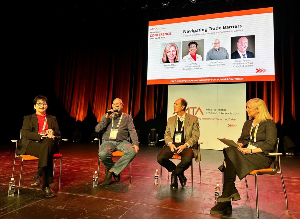 Four people sitting on a stage