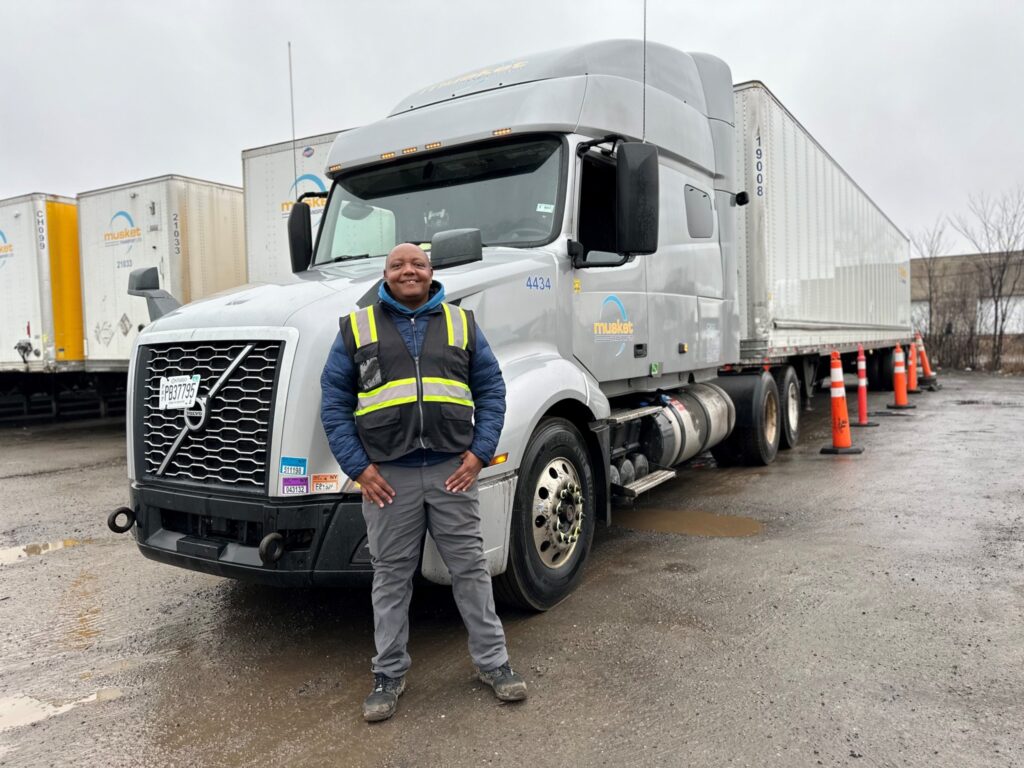 Daniel Wanyeki in front of a Musket Transport truck