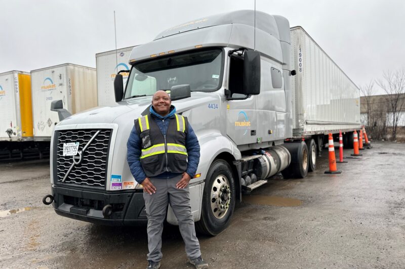 Daniel Wanyeki in front of a Musket Transport truck