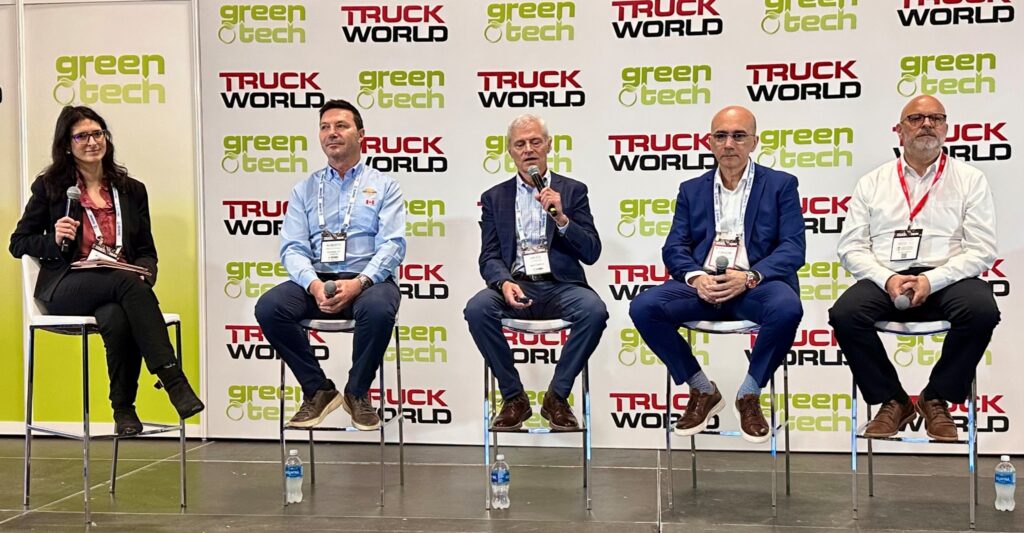 Five people seated on a stage