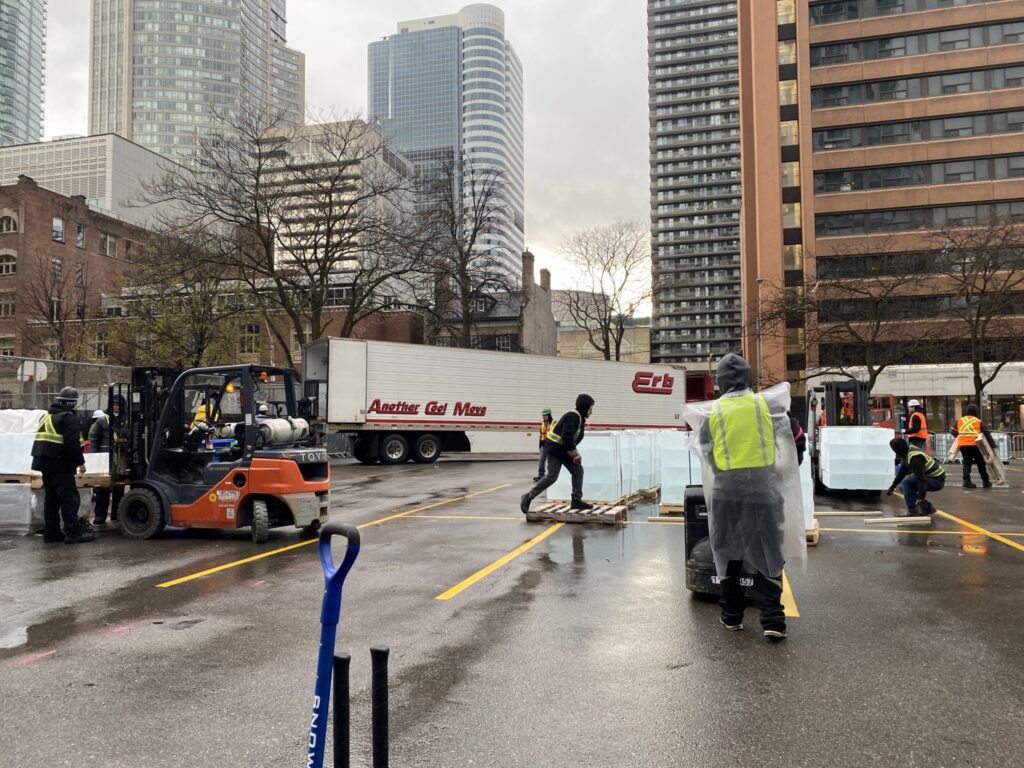view from above, shipment of ice is being unloaded and assembled into an ice tower
