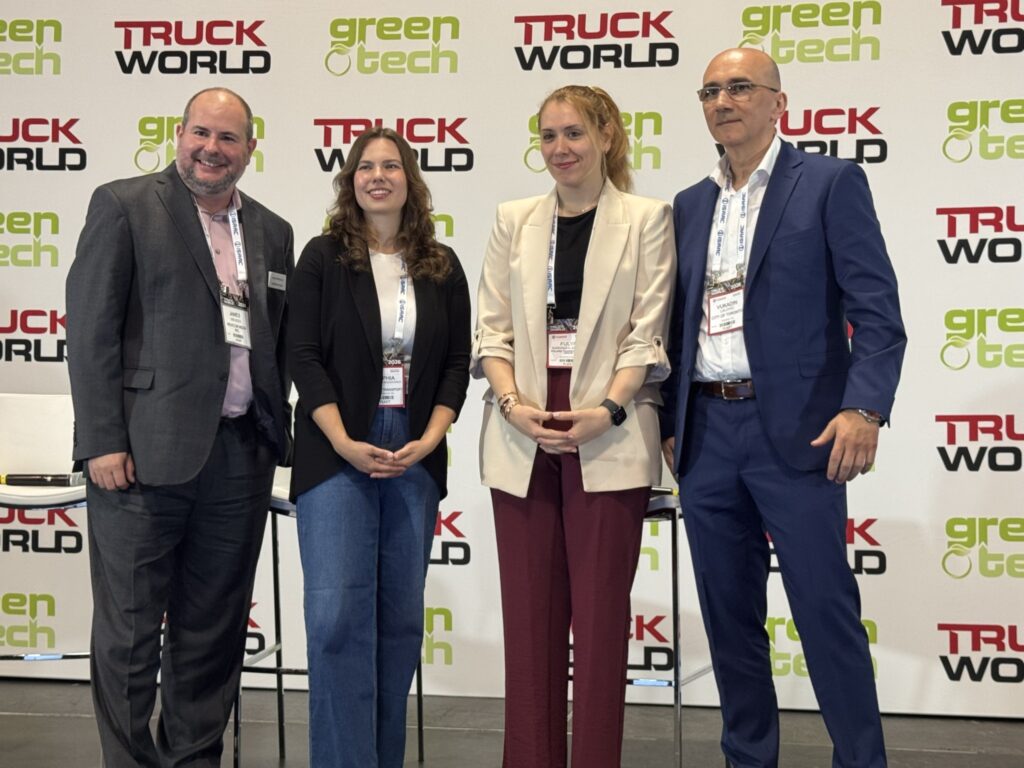 group photo of moderator and three panelists on stage