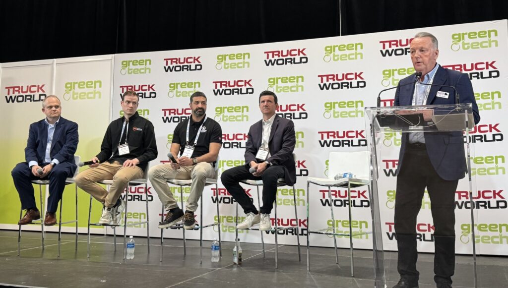 Four panelists and moderator on GreenTech stage during Truck World 2026