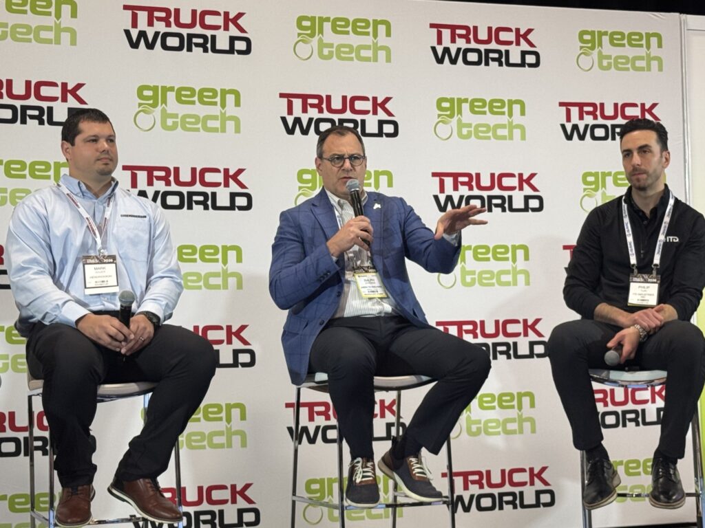 three panelists on stage