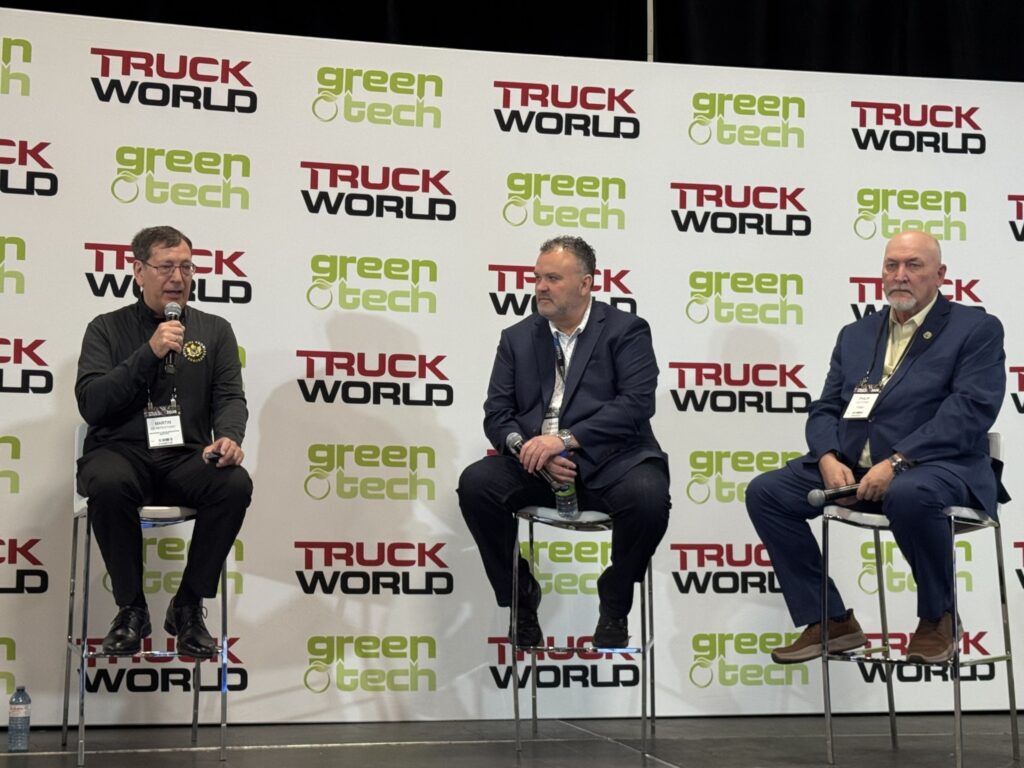 three panelists sitting on stage 