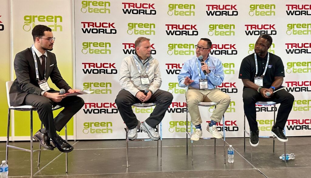 Four men sitting on a stage