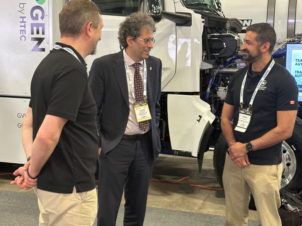 People talking in front of a truck at Truck World 2026 