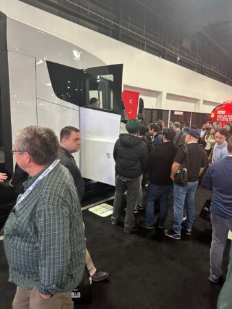 A crowd of people, in line to get into Tesla Semi
