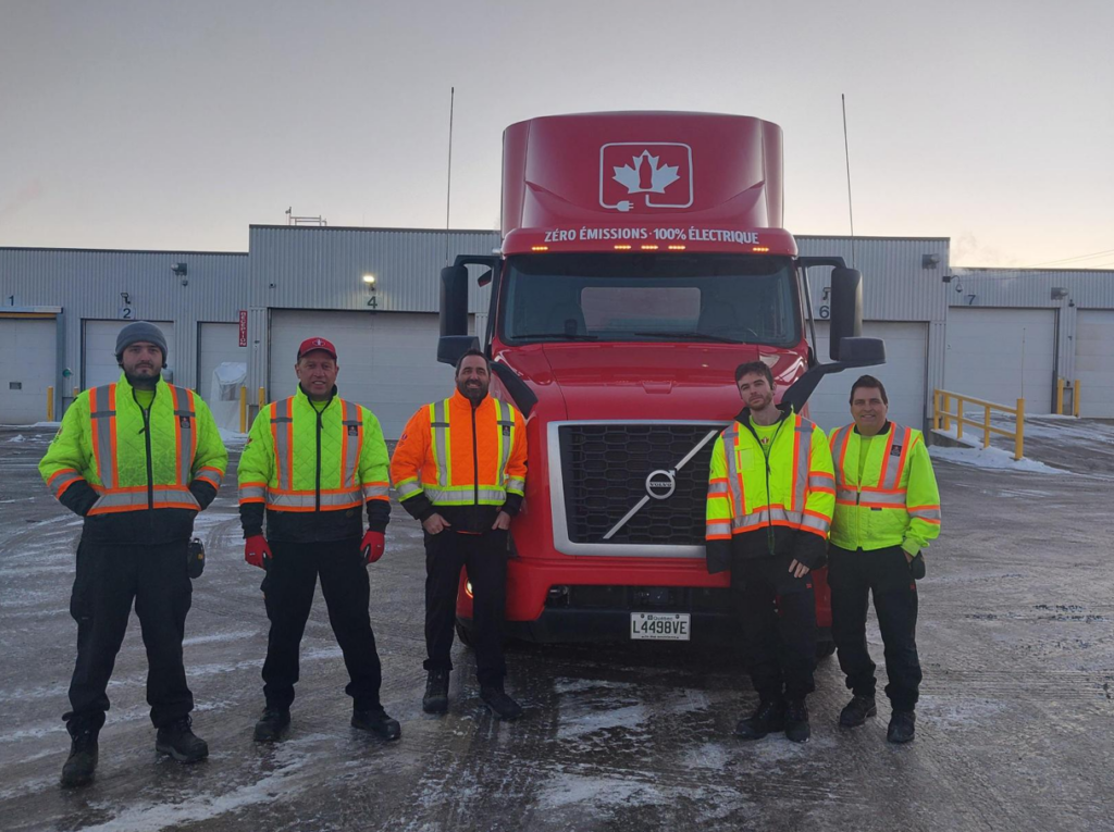 Coke Canada Bottling employees alongside new Volvo VNR Electric fleet in Quebec City