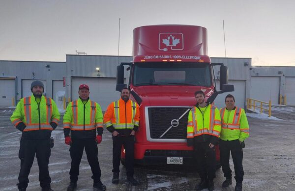 Coke Canada Bottling employees alongside new Volvo VNR Electric fleet in Quebec City