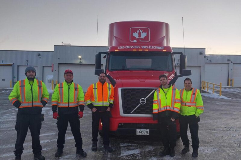 Coke Canada Bottling employees alongside new Volvo VNR Electric fleet in Quebec City