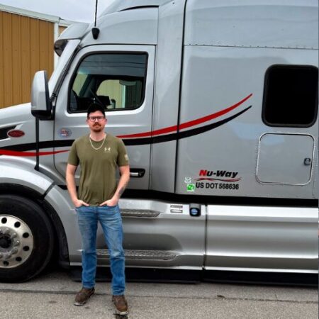 Driver Wade Dickinson in front of his truck