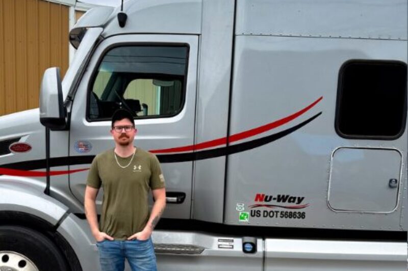 Driver Wade Dickinson in front of his truck
