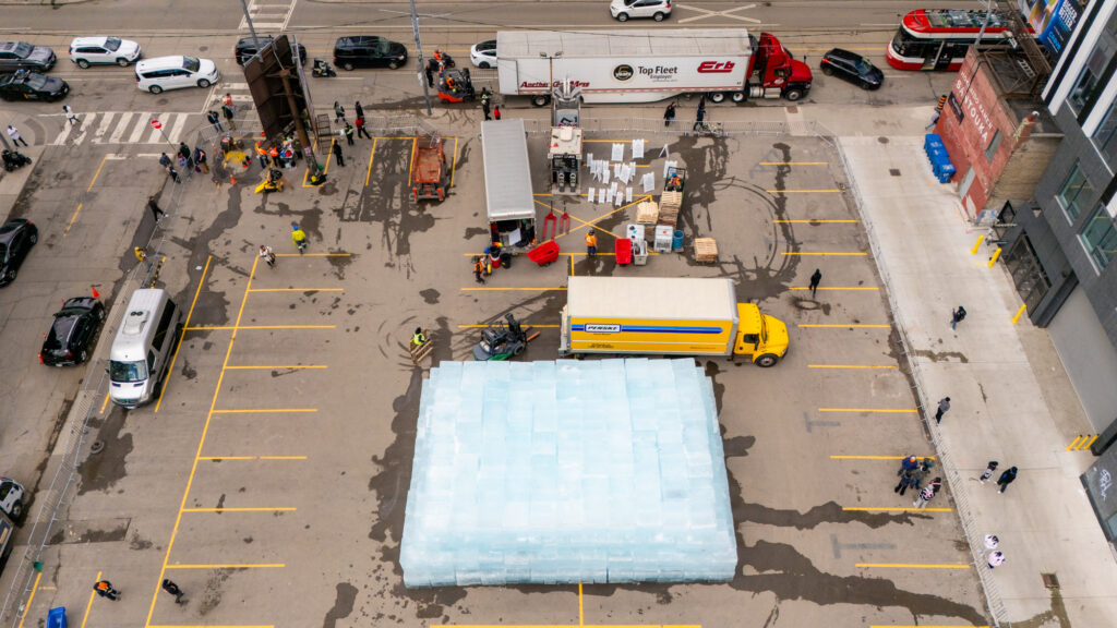 view from above, shipment of ice is being unloaded and assembled into an ice tower
