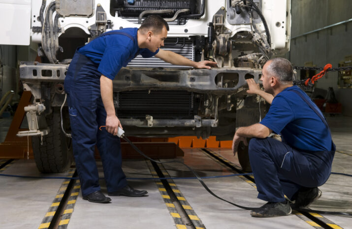 Technicians works on a truck.