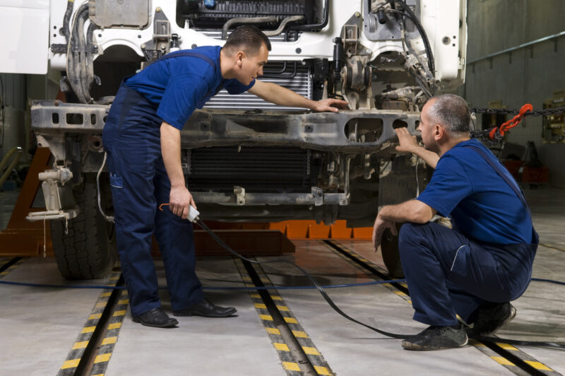 Technicians works on a truck.