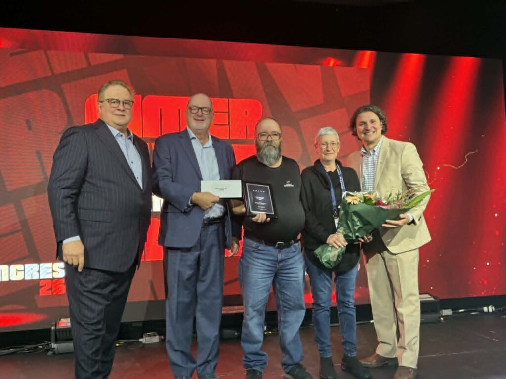 Michel Francoeur and his wife, Gayle Cooke, are joined by Marc Cadieux, president and CEO of the Association du camionnage du Québec, Alain Delisle of Volvo Trucks Canada, and David Morneau, chair of the ACQ board.