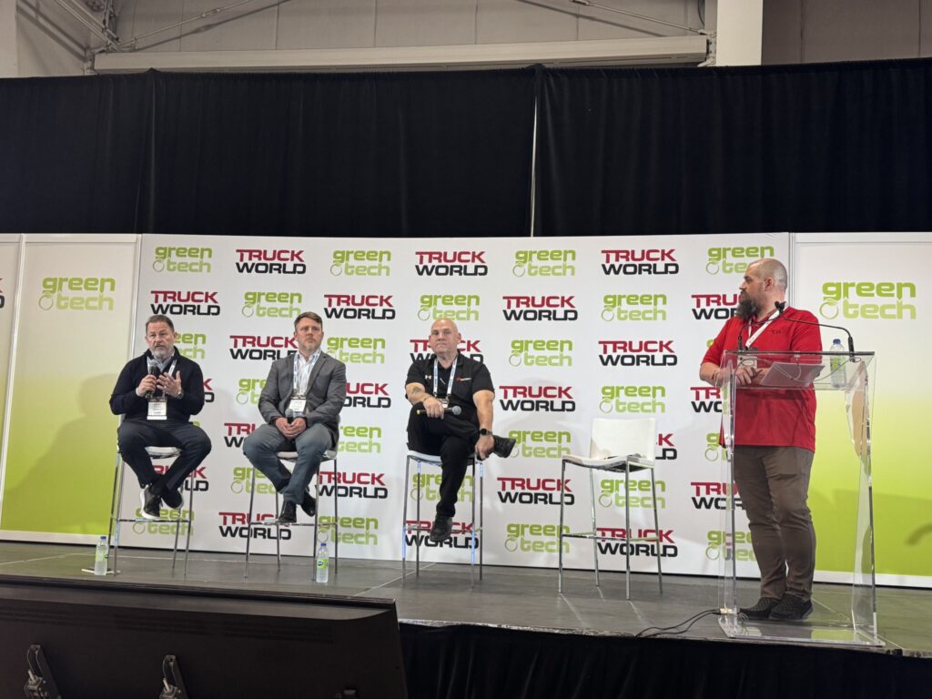 three panelists and a moderator on stage