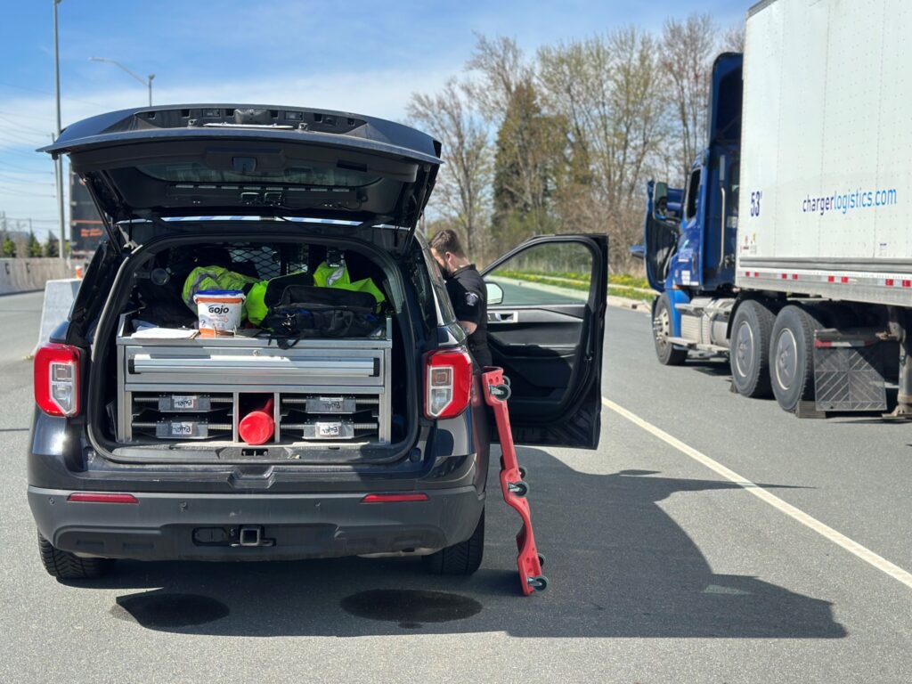 A crusier is parked next to a truck