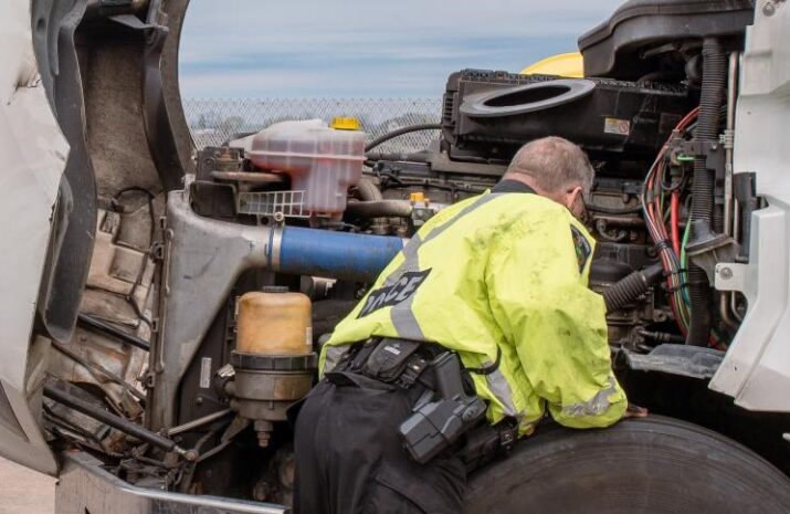 An officer inspects a truck