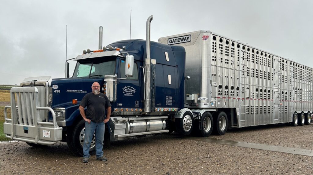 Picture of Trevor Currie in front of a truck
