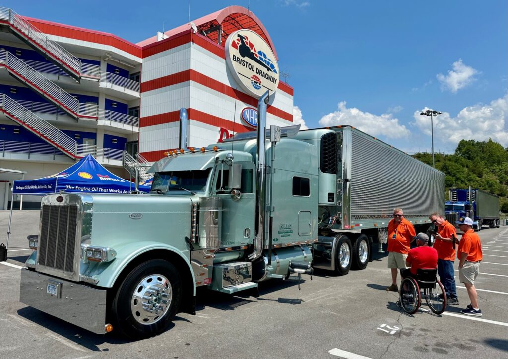 People chatting in front of a truck