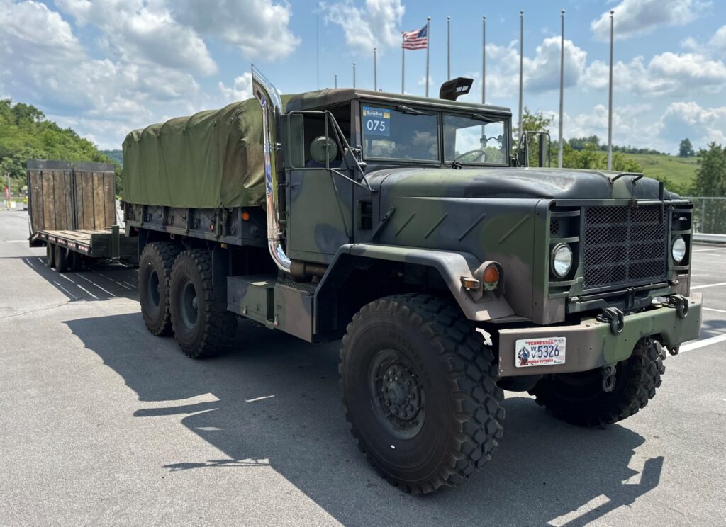 A truck and trailer painted in camo colors