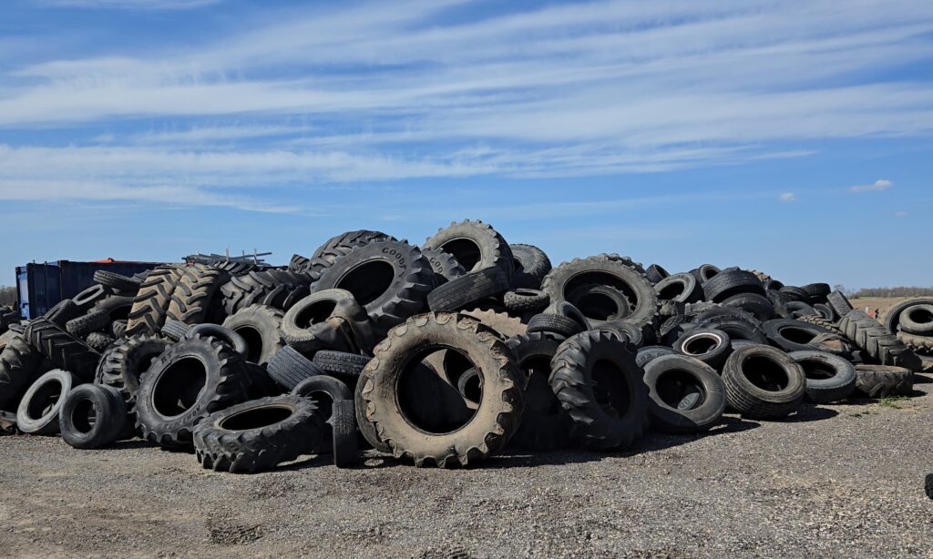 scrap tires, including commercial, pilled up in a yard
