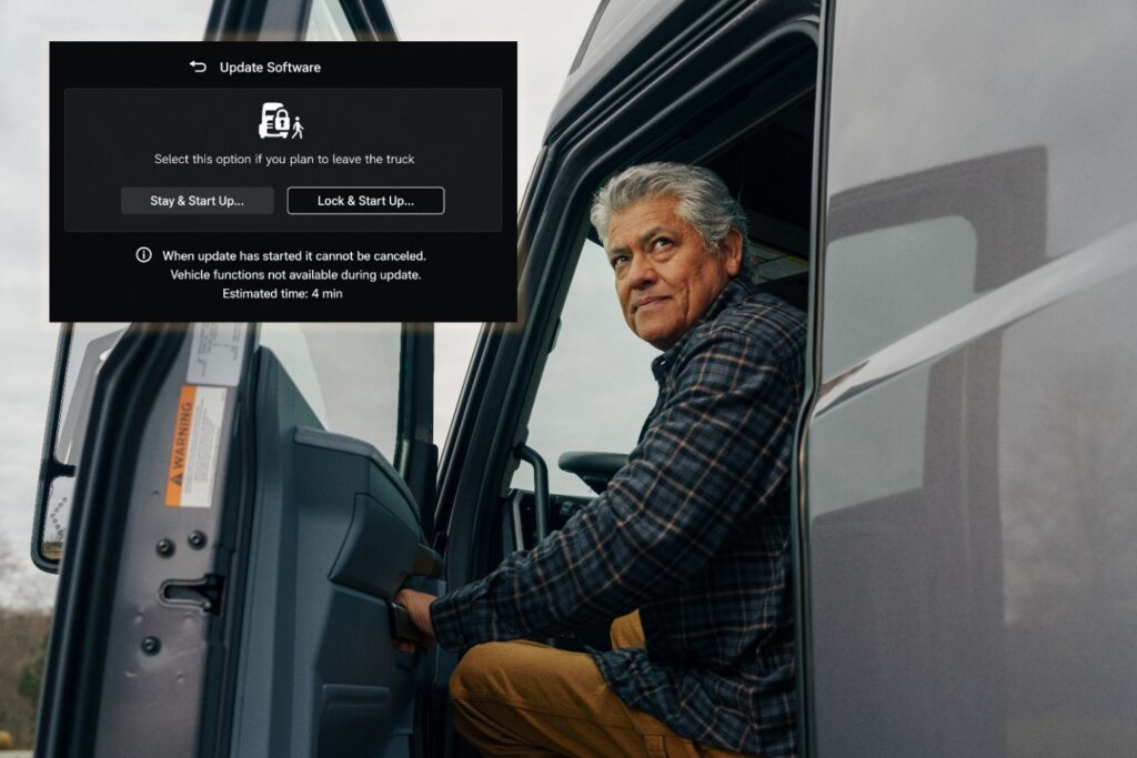 A driver in the cab of a Mack with open door